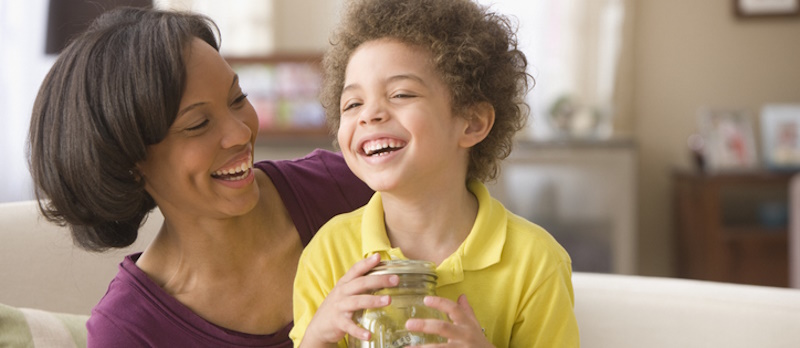 Mom teaching her son to save money