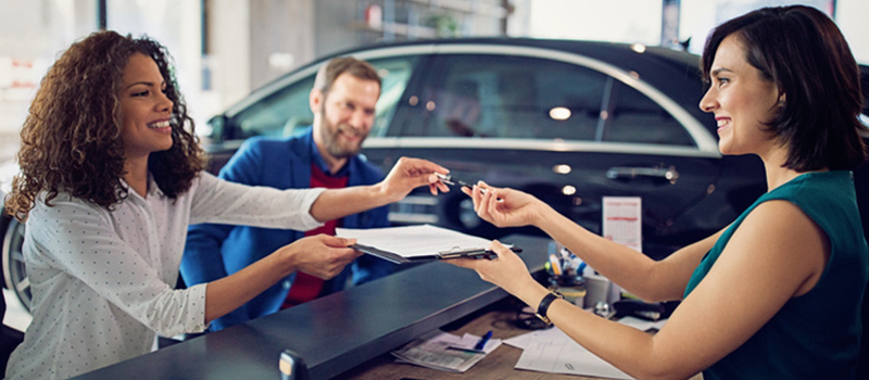 Woman signing paperwork for her car